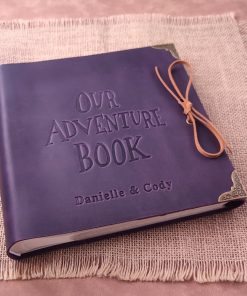 Beautiful purple scrapbook titled Our Adventure Book, perfect anniversary gift for couples.