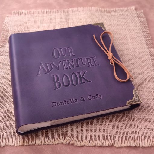Beautiful purple scrapbook titled Our Adventure Book, perfect anniversary gift for couples.